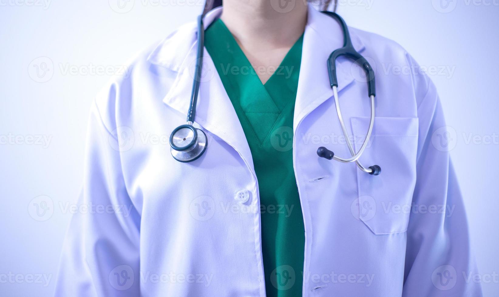 Midsection Of Doctor Gesturing While Standing Against Wall photo
