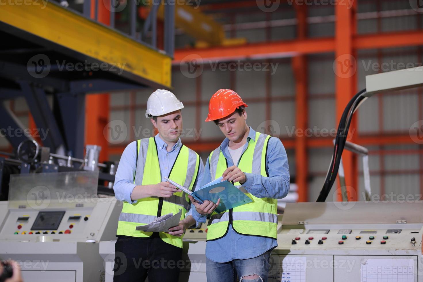 Industry worker Foreman or worker work at factory site check up machine or products in site. Engineer or Technician checking Material or Machine on Plant. Industrial and Factory. photo