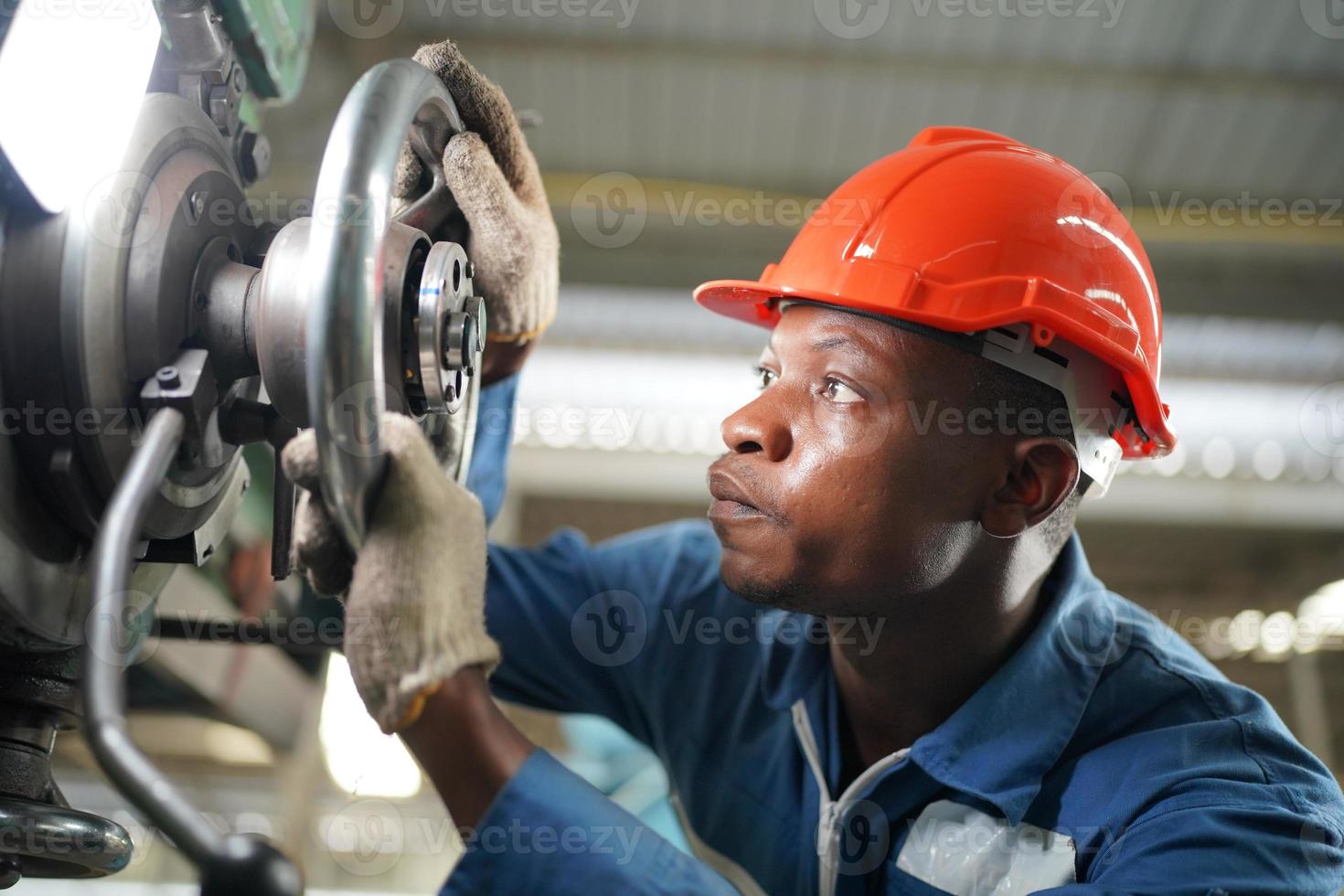 Maintenance Engineers is working in front of the automated CNC machinery repair on a maintenance checklist at the production line. photo