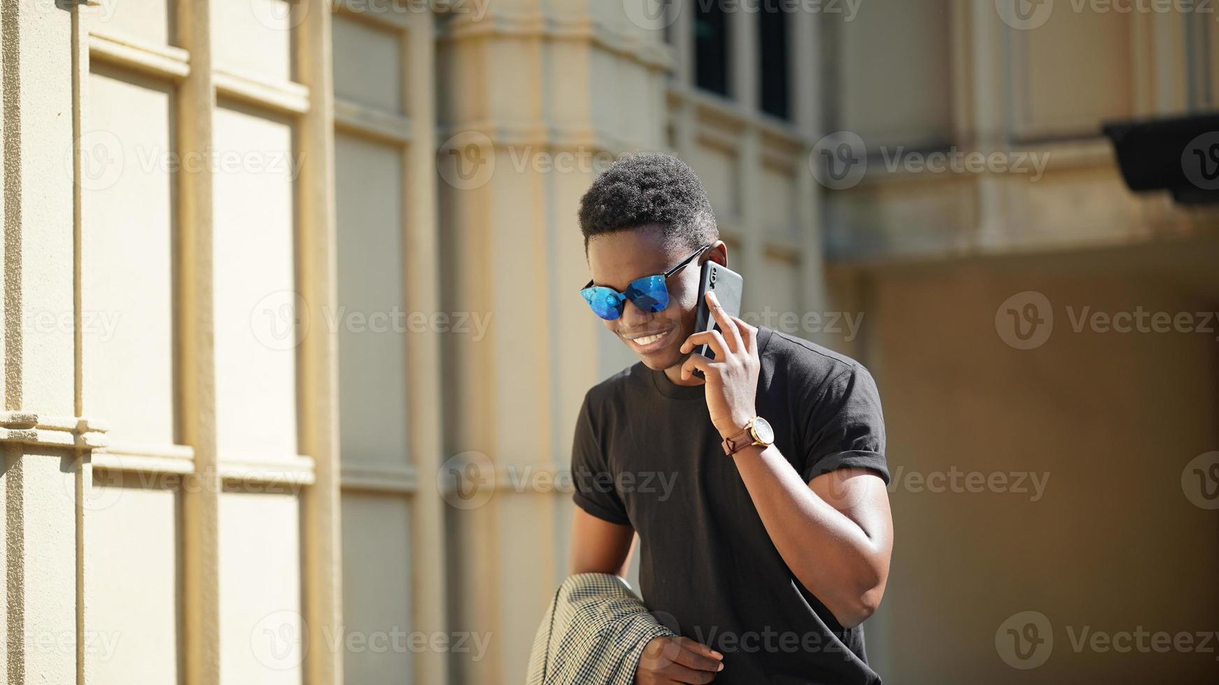 Afro American man having fun walking in city center - Happy young guy enjoying time a sunset outdoor - Millennial generation lifestyle and positive people attitude concept photo