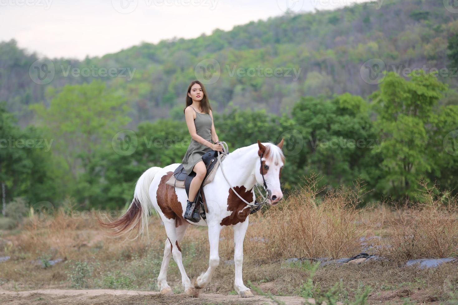 Young woman with her horse in evening sunset light. Outdoor photography with fashion model girl. Lifestyle mood photo