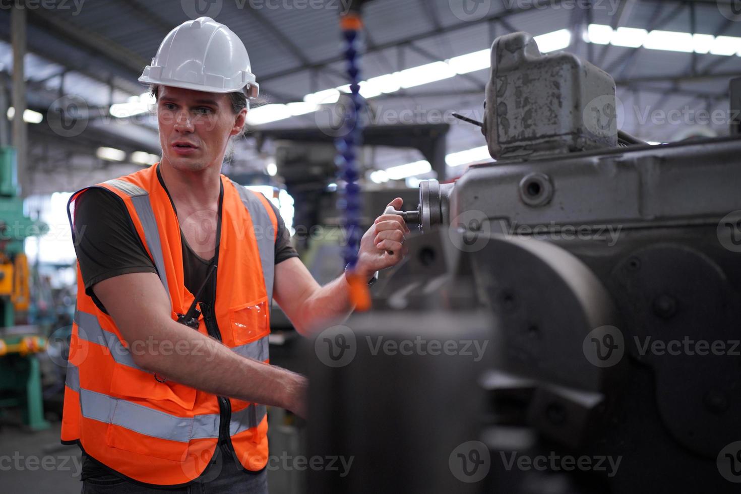 Maintenance Engineers is working in front of the automated CNC machinery repair on a maintenance checklist at the production line. photo