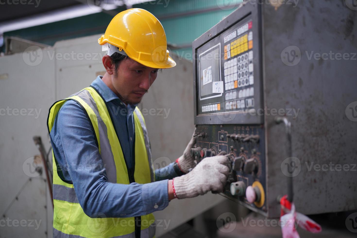 Maintenance Engineers is working in front of the automated CNC machinery repair on a maintenance checklist at the production line. photo