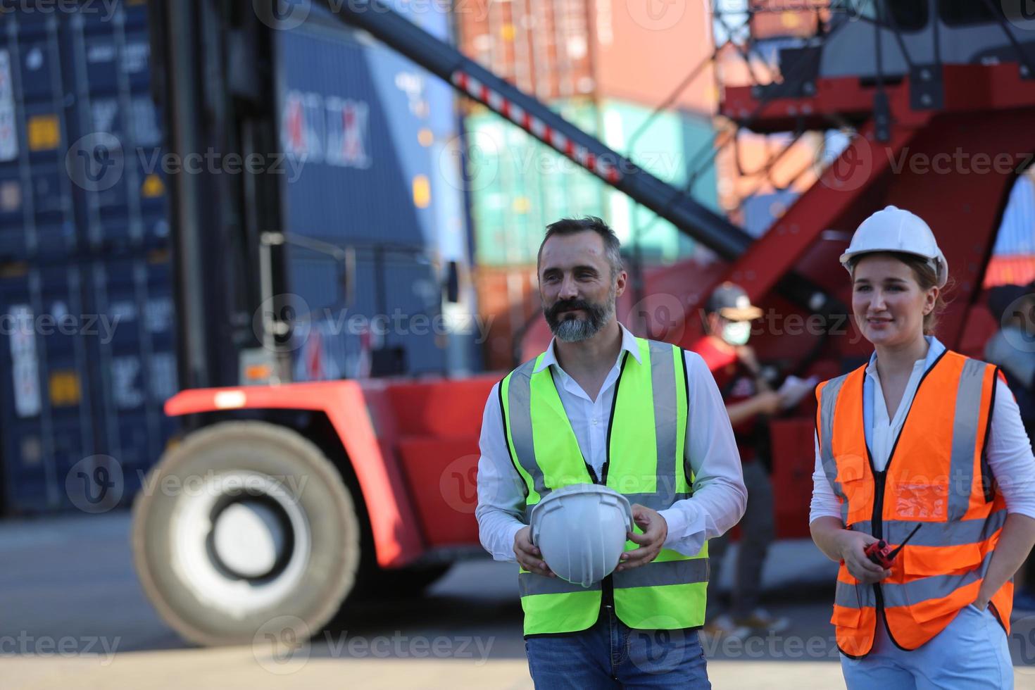 Foreman checking containers in the terminal, at import and export business logistic company. photo