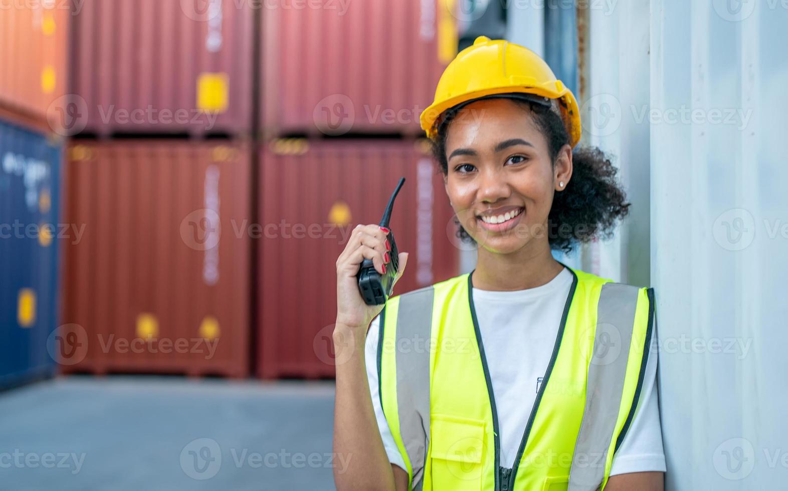 Foreman control loading Containers box from Cargo freight ship for import export. photo