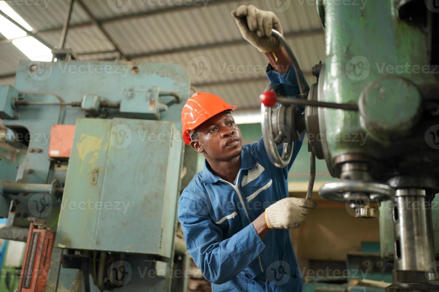 Maintenance Engineers is working in front of the automated CNC machinery repair on a maintenance checklist at the production line. photo