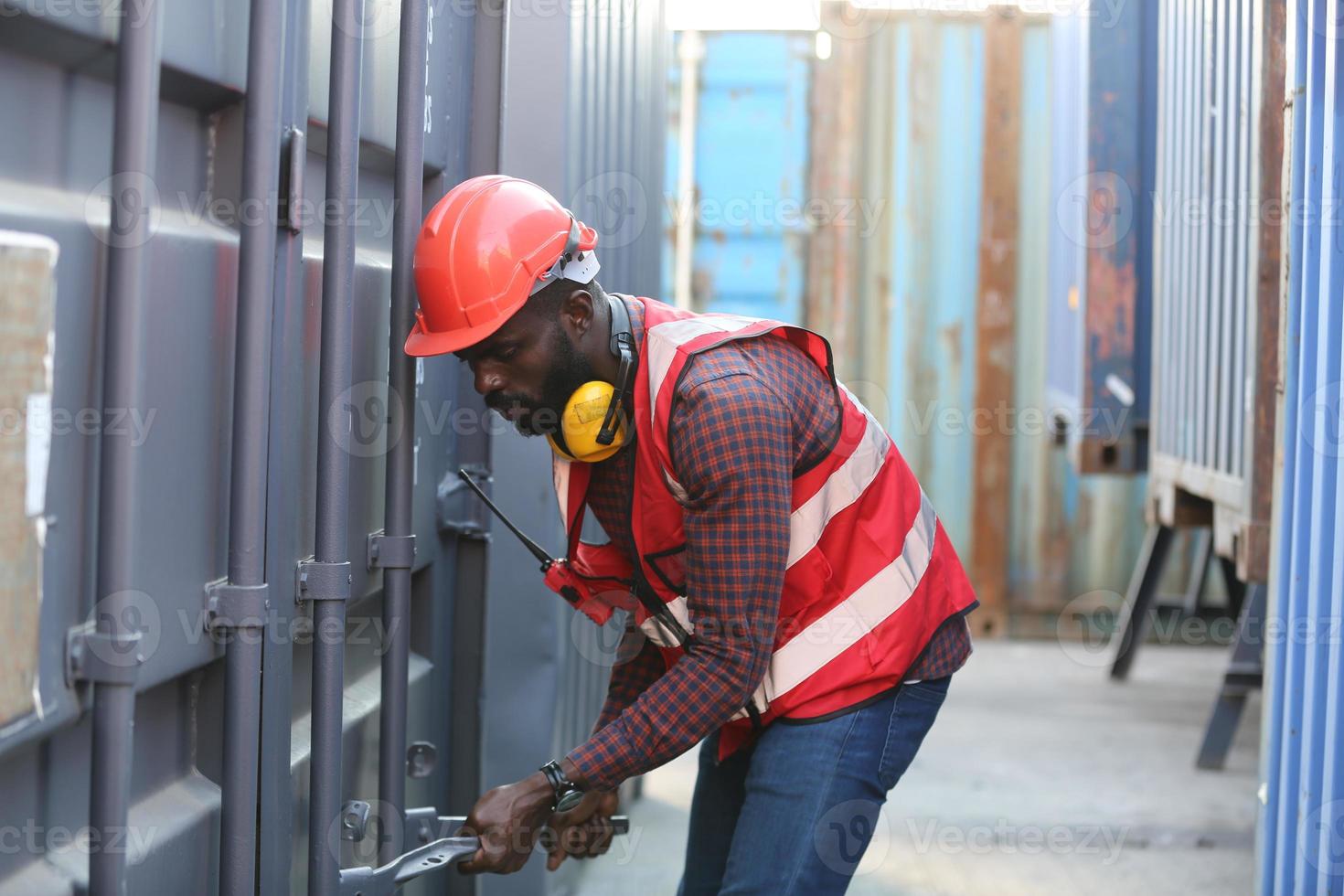 Engineer or supervisor checking and control loading Containers box from Cargo at harbor. Foreman control Industrial Container Cargo freight ship at industry. Transportation and logistic concept. photo