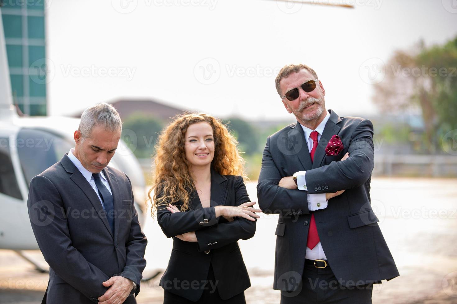 Successful business people standing together widen out showing strong relationship of worker community. A team of businessman and businesswoman expressing a strong group teamwork at the modern office. photo