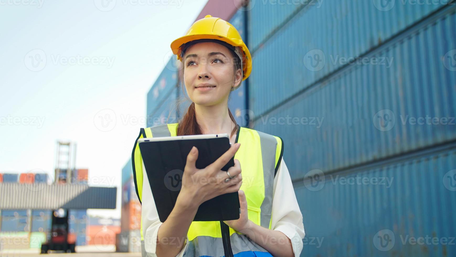 Female Foreman checking containers for ship at terminal port. photo