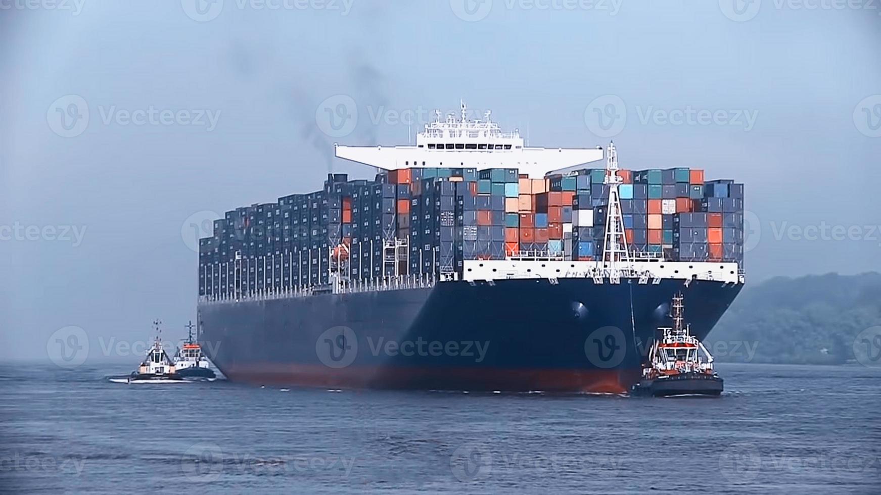 Container loading in a Cargo freight ship with industrial crane. Container ship in import and export business logistic company. Industry and Transportation concept. photo