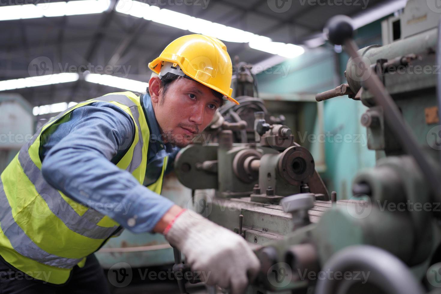 Maintenance Engineers is working in front of the automated CNC machinery repair on a maintenance checklist at the production line. photo