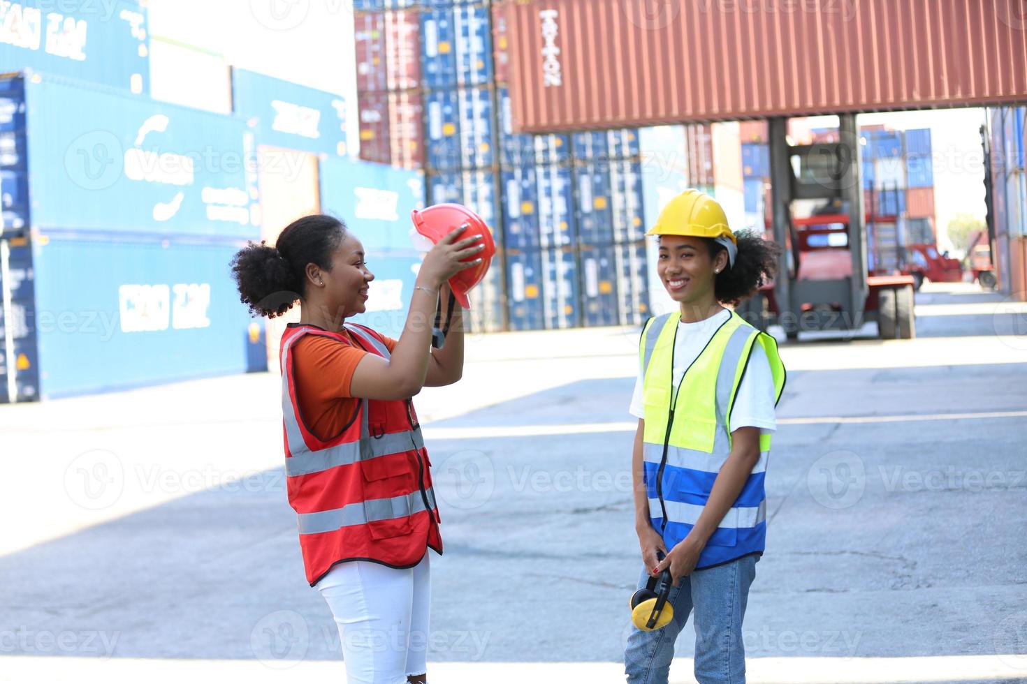 Foreman control loading Containers box from Cargo freight ship for import export. photo