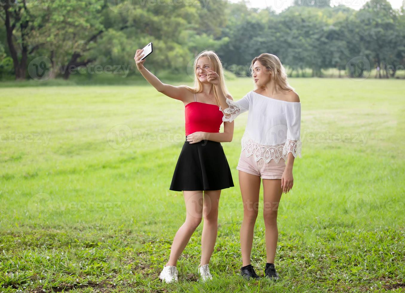 Close Up Portrait of beauty girl with fluttering white hair enjoying nature outdoors, on a field. Flying blonde hair on the wind. Breeze playing with girl's hair. Beautiful young woman face photo