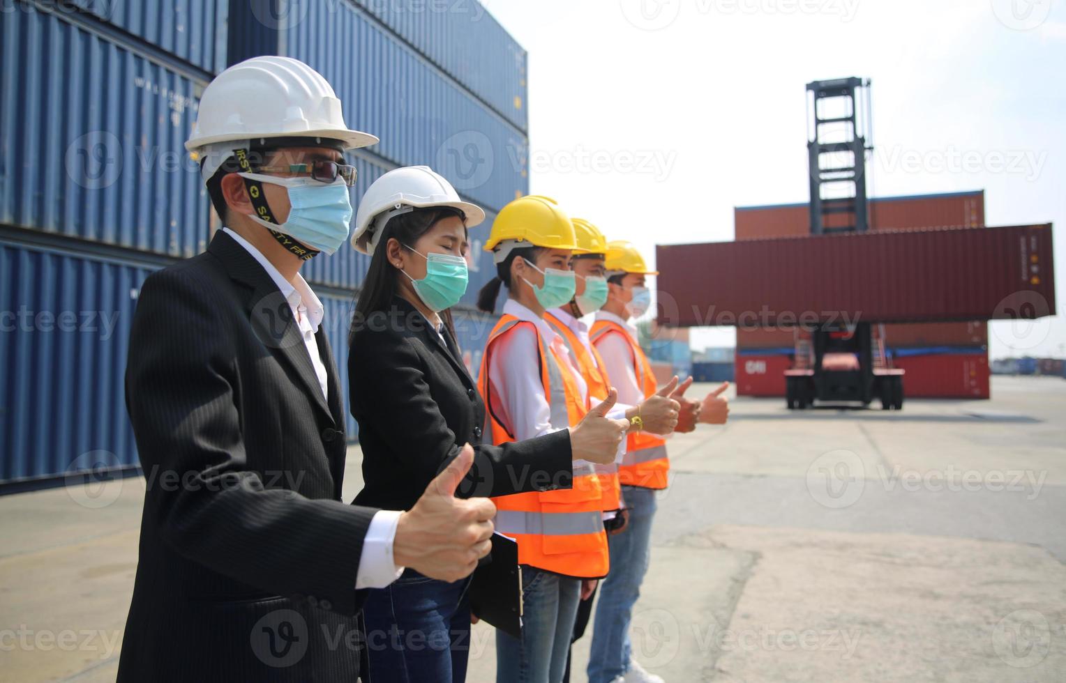 Foreman control loading Containers box from Cargo freight ship for import export. photo