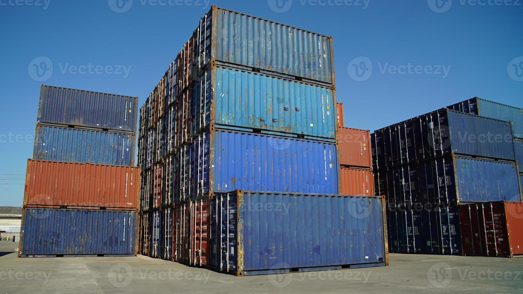 Foreman control loading Containers box from Cargo freight ship for import export. photo