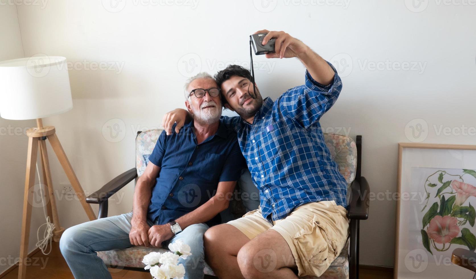 A portrait of adult hipster son and senior father spend time together on weekend at home. photo