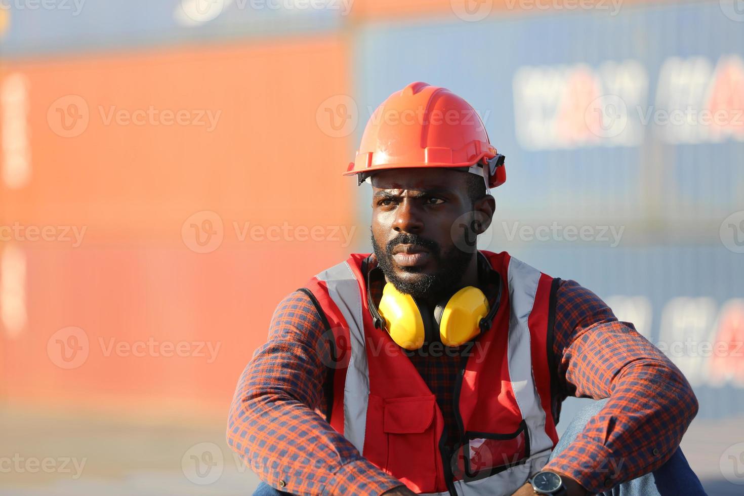 Engineer or supervisor checking and control loading Containers box from Cargo at harbor. Foreman control Industrial Container Cargo freight ship at industry. Transportation and logistic concept. photo