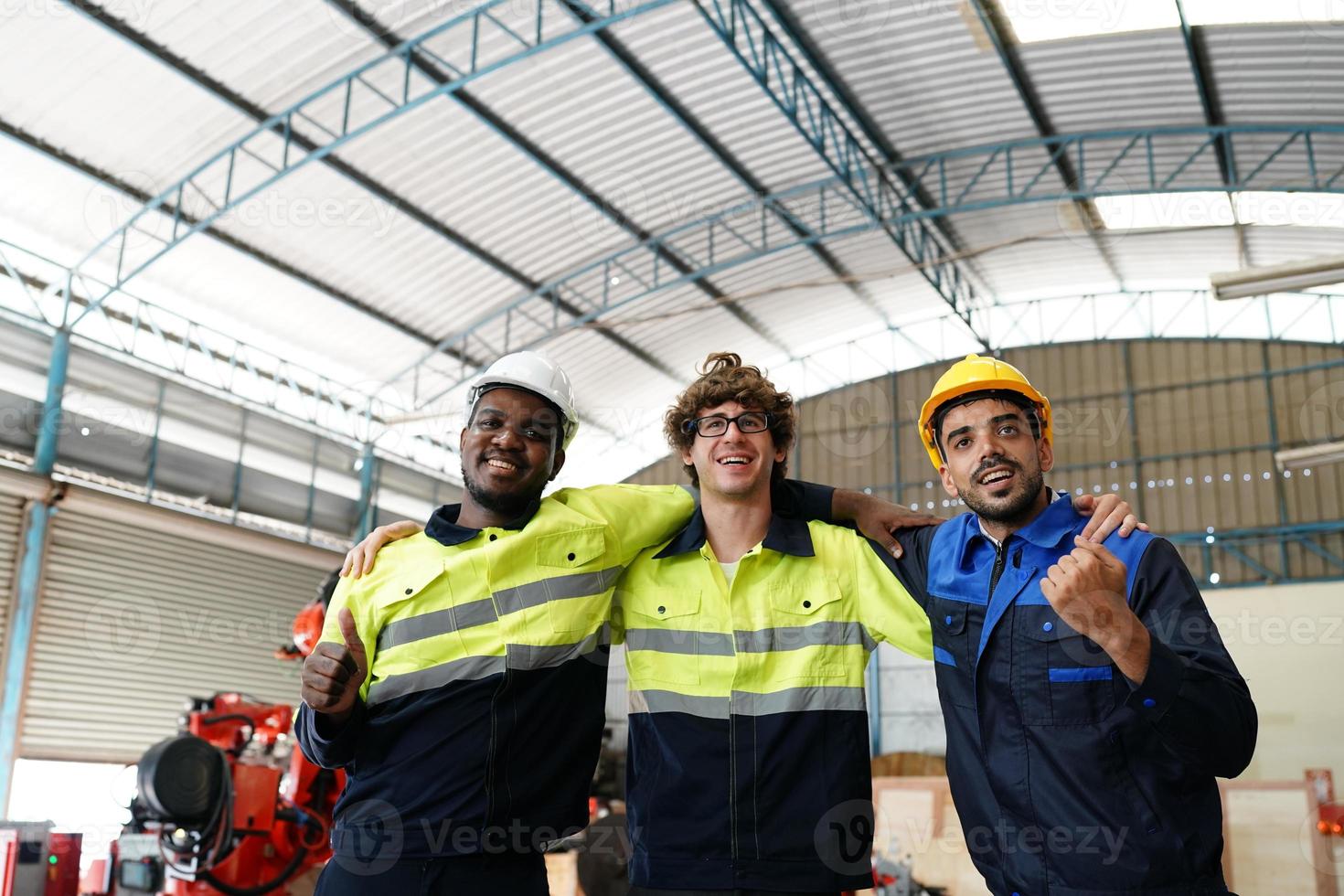 Industrial engineer or worker wearing a helmet while standing in a heavy industrial factory. The Maintenance looking of working at industrial machinery and check security system setup in factory. photo