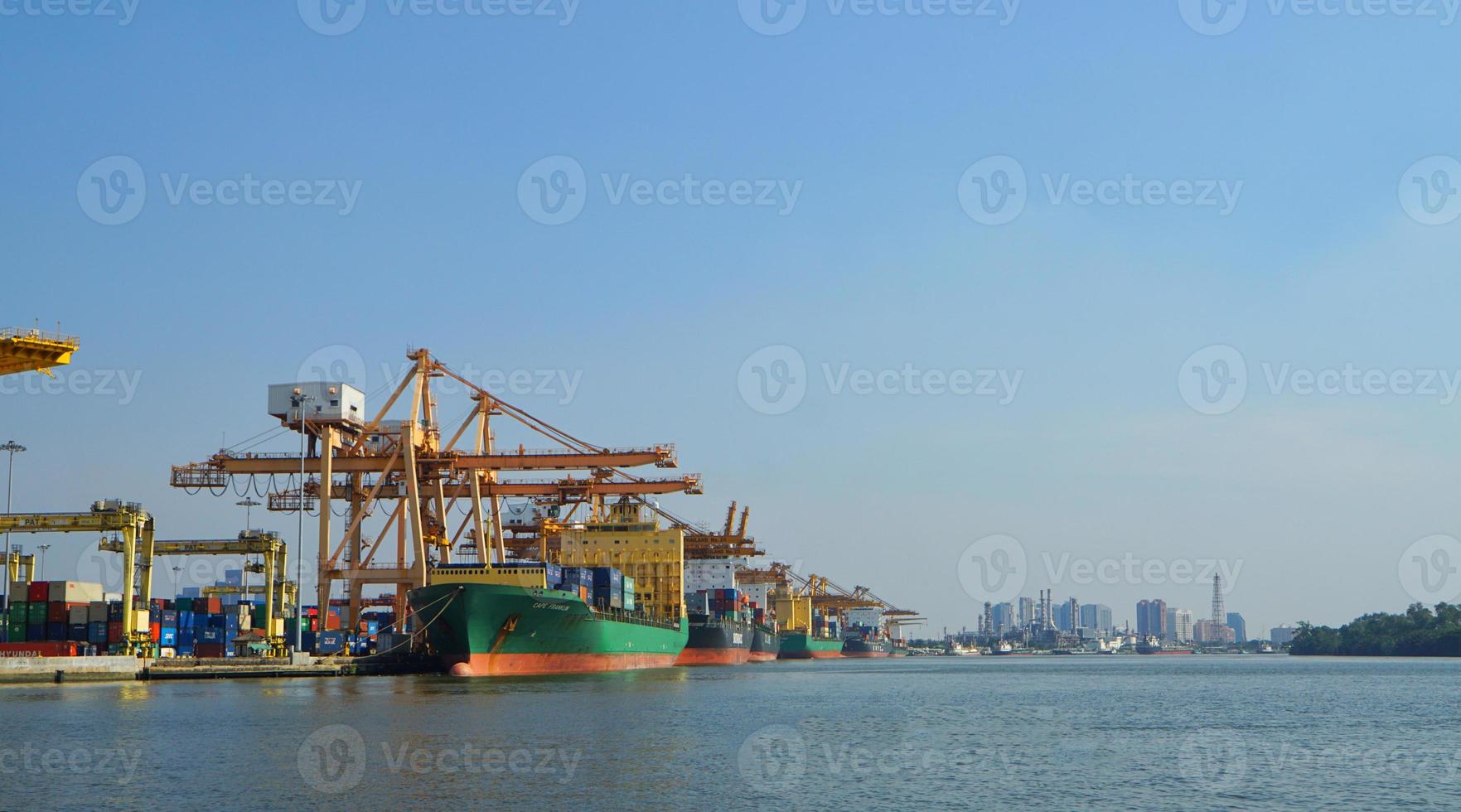 Container loading in a Cargo freight ship with industrial crane. Container ship in import and export business logistic company. Industry and Transportation concept. photo