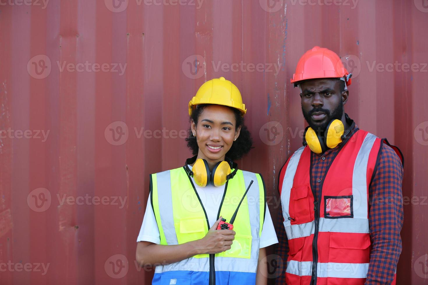 Foreman control loading Containers box from Cargo freight ship for import export. photo