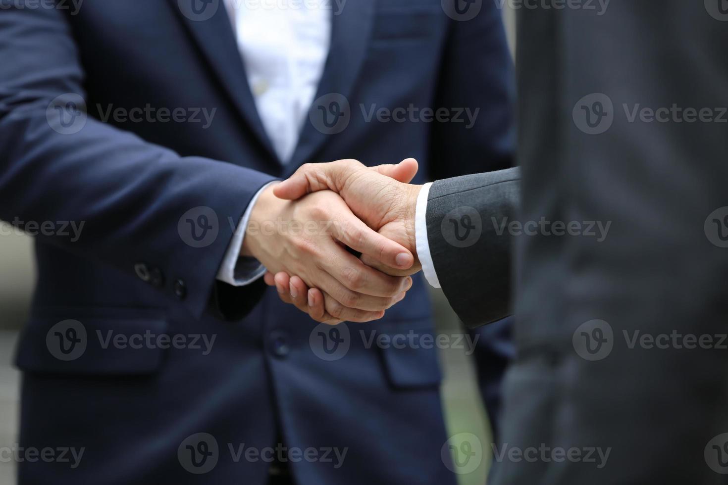 Business people shaking hands after successful negotiations photo