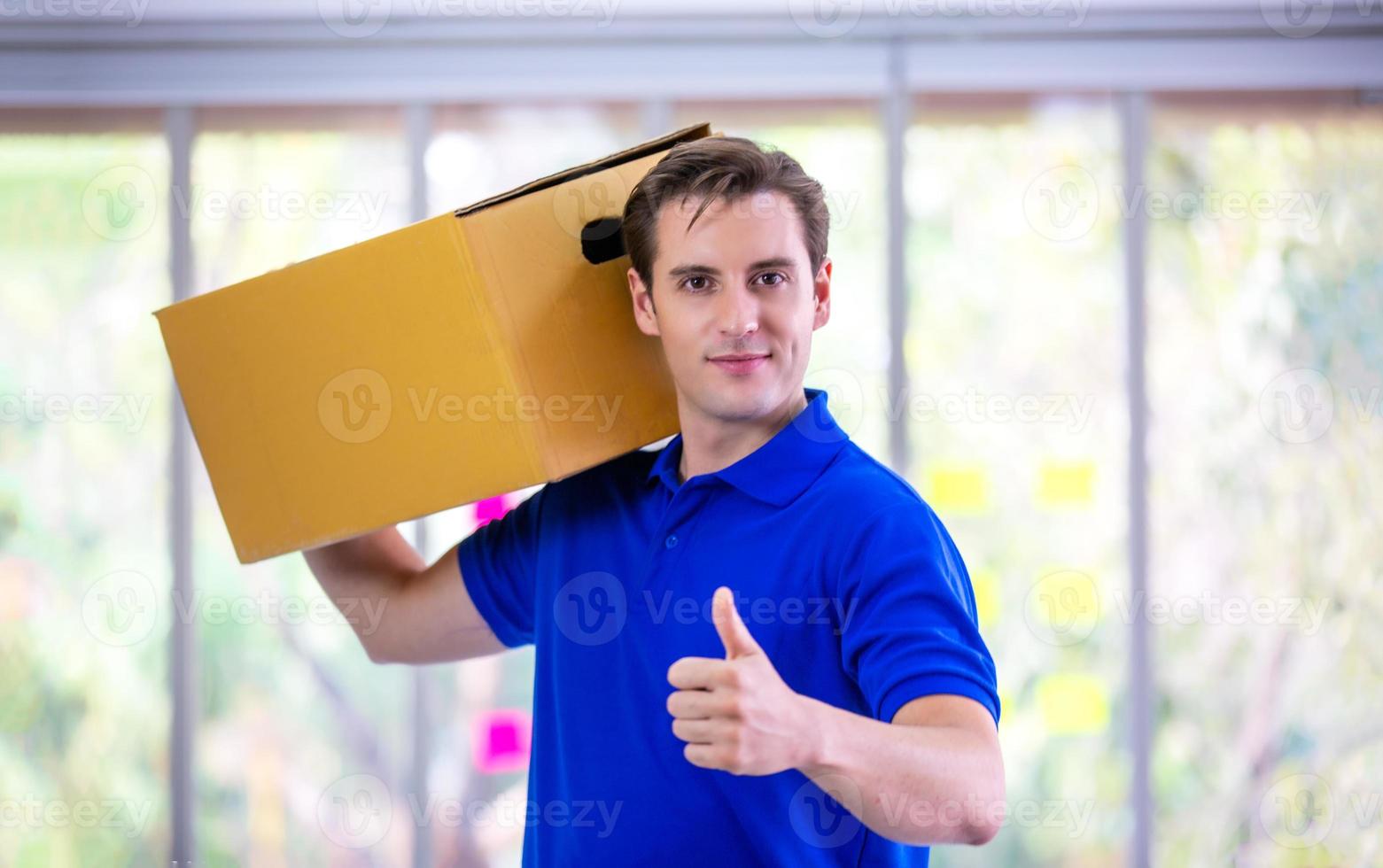 delivery man blue t-shirt holding box in call center office photo