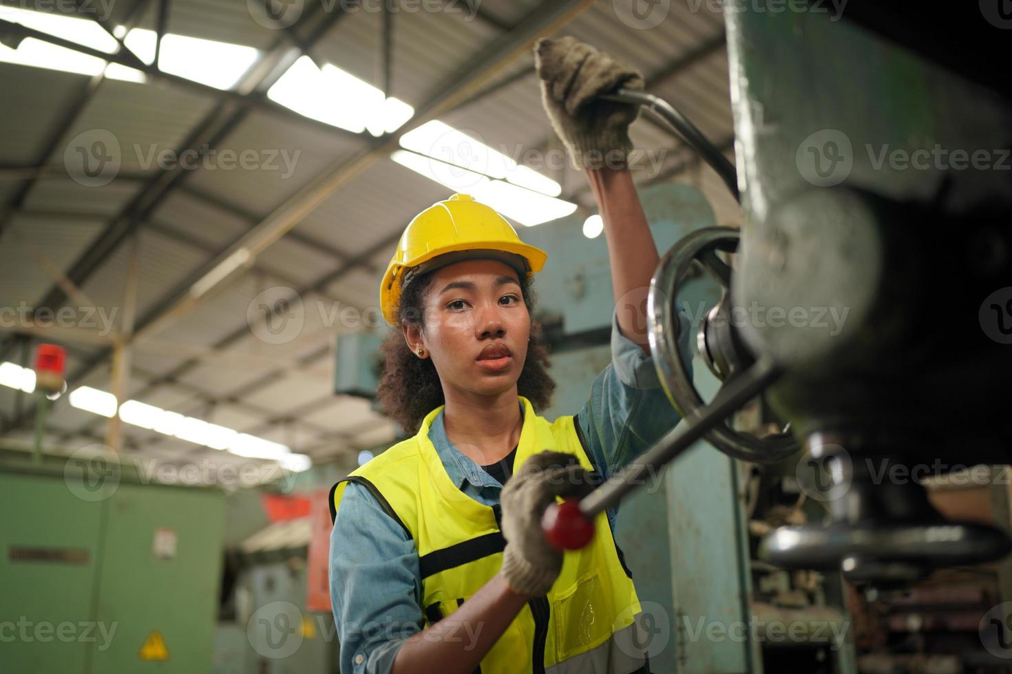 Female Maintenance Engineers is working in front of the automated CNC machinery repair on a maintenance checklist at the production line. photo