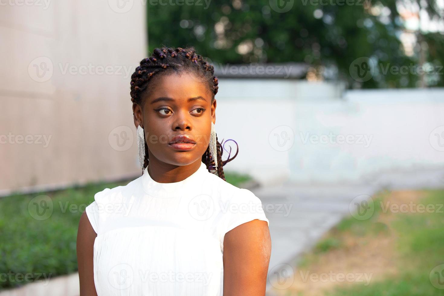 Young Black skin African American woman wearing casual clothes, standing on city background on positive, smiling confident. Self-love and self-care photo