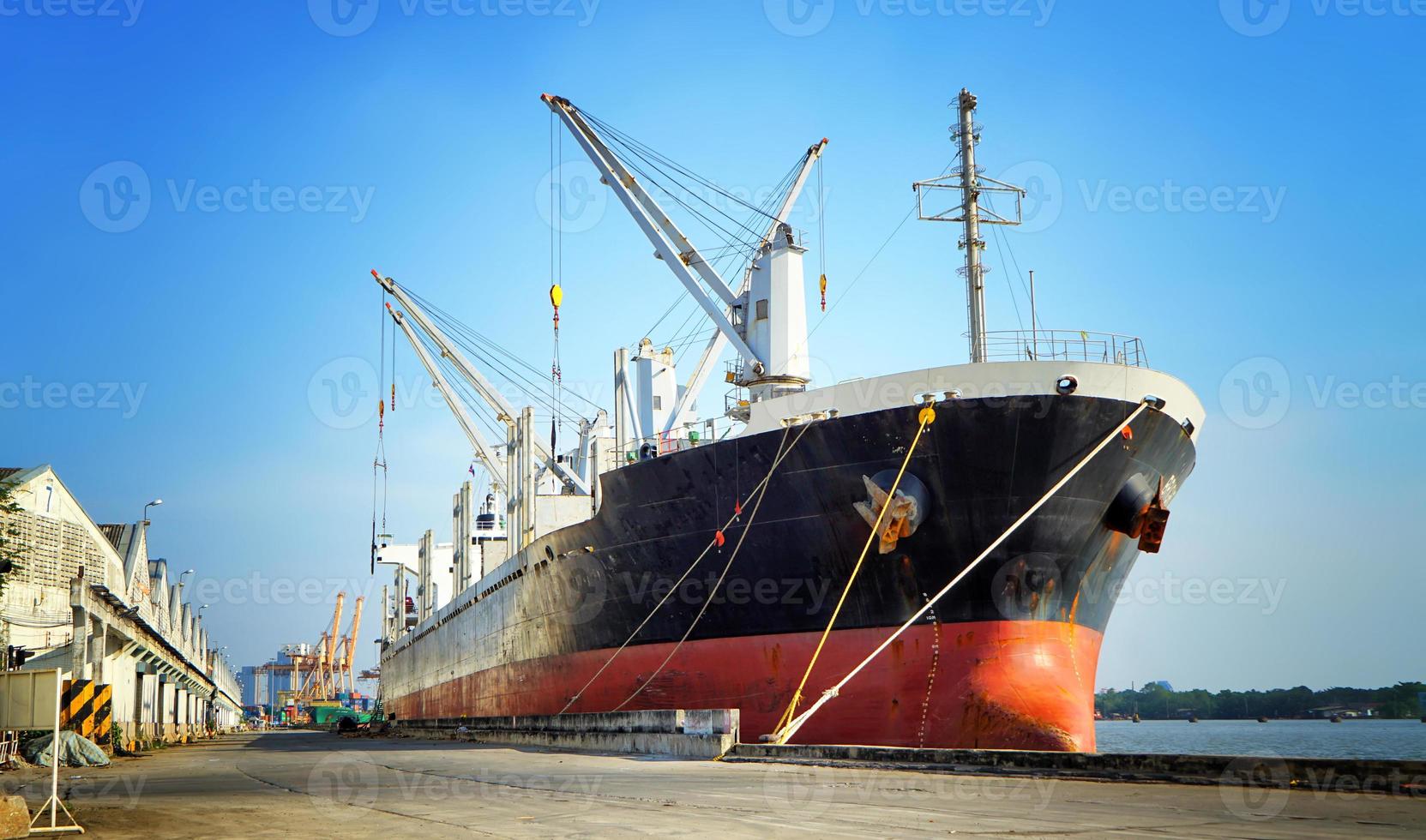 Container loading in a Cargo freight ship with industrial crane. Container ship in import and export business logistic company. Industry and Transportation concept. photo