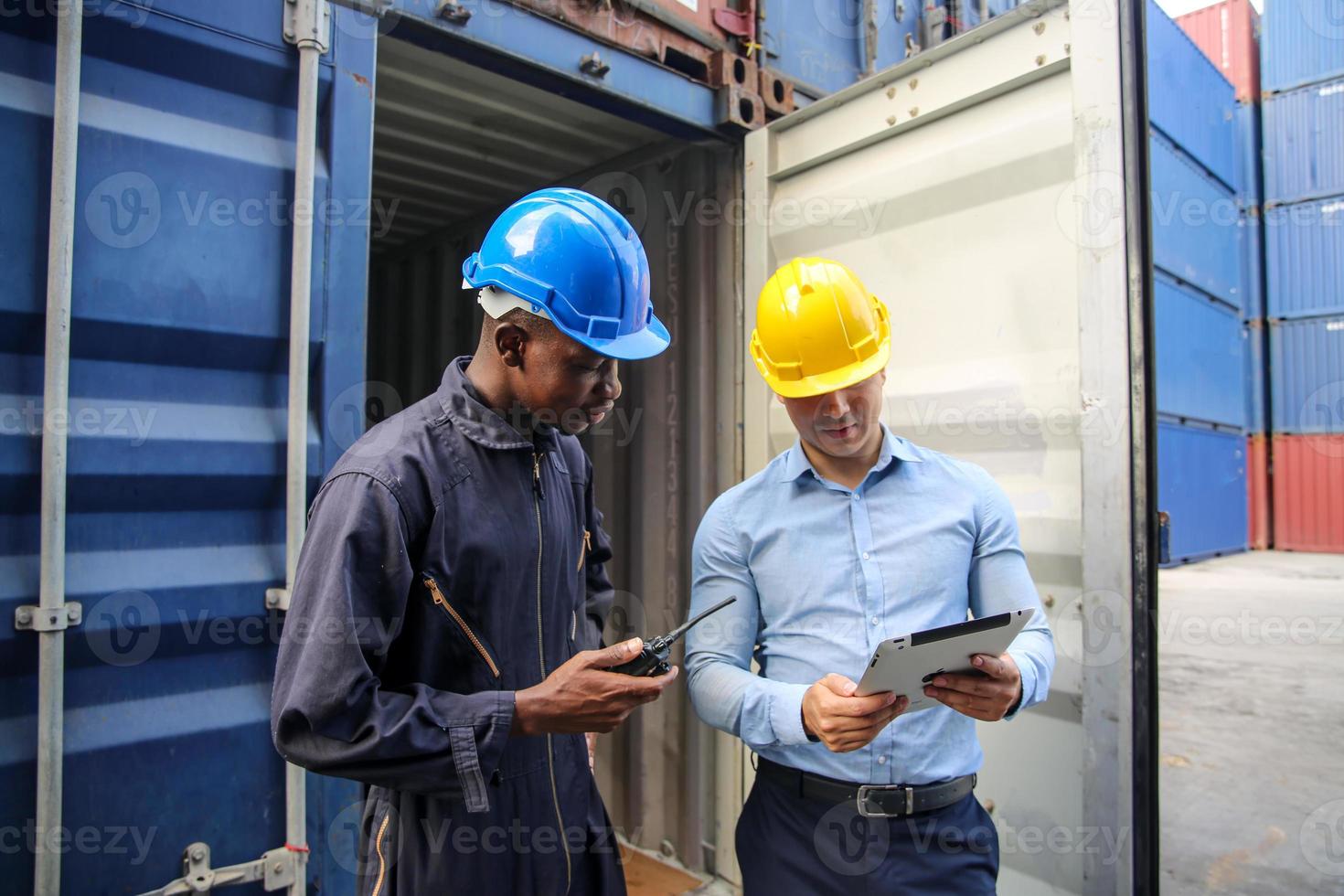 Foreman control loading Containers box from Cargo freight ship for import export. photo