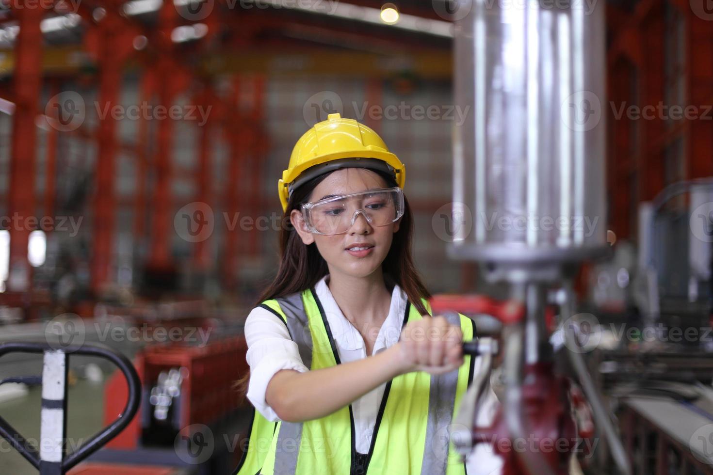 Female worker Foreman or worker work at factory site check up machine or products in site. Engineer or Technician checking Material or Machine on Plant. Industrial and Factory. photo