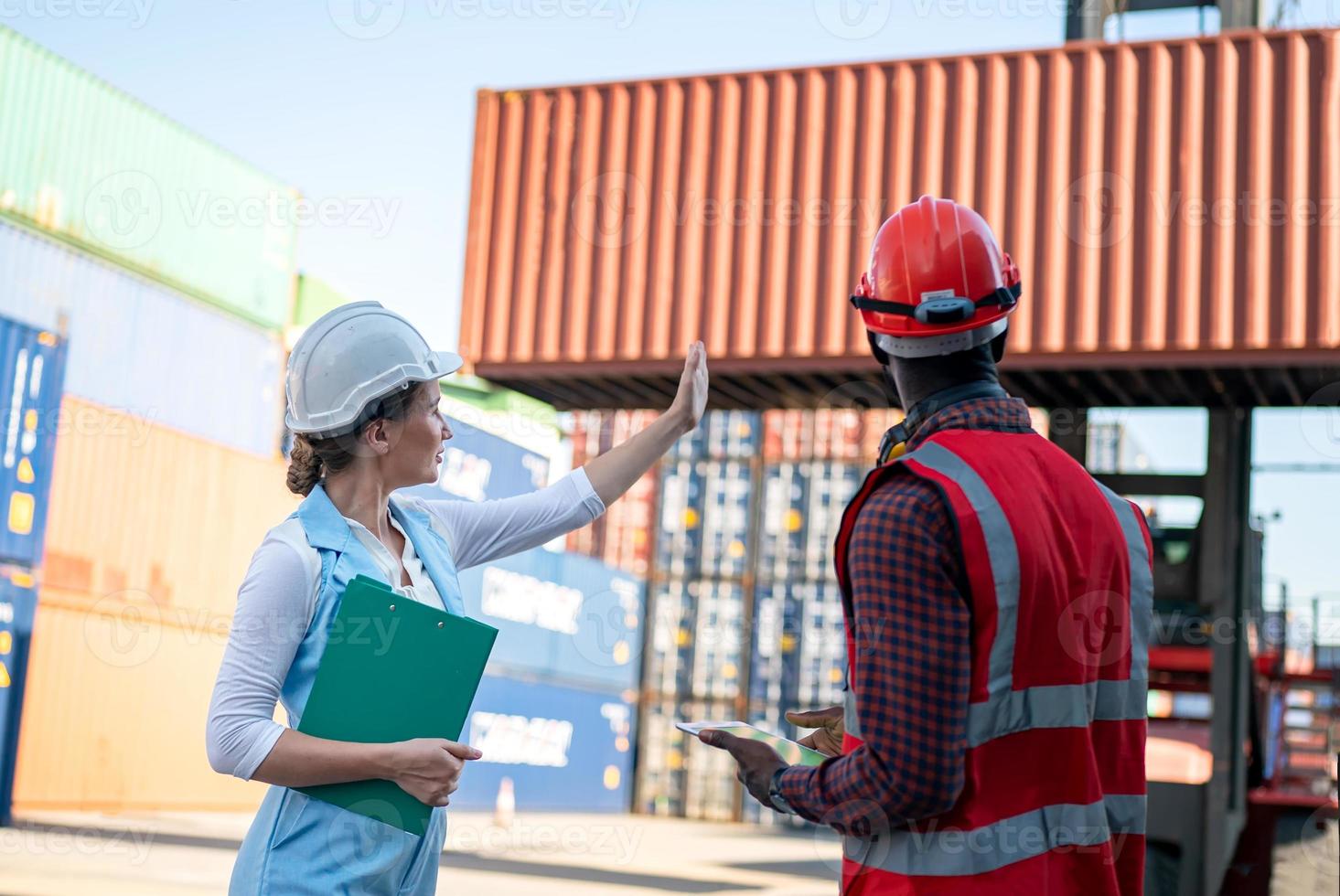 Foreman checking containers in the terminal, at import and export business logistic company. photo