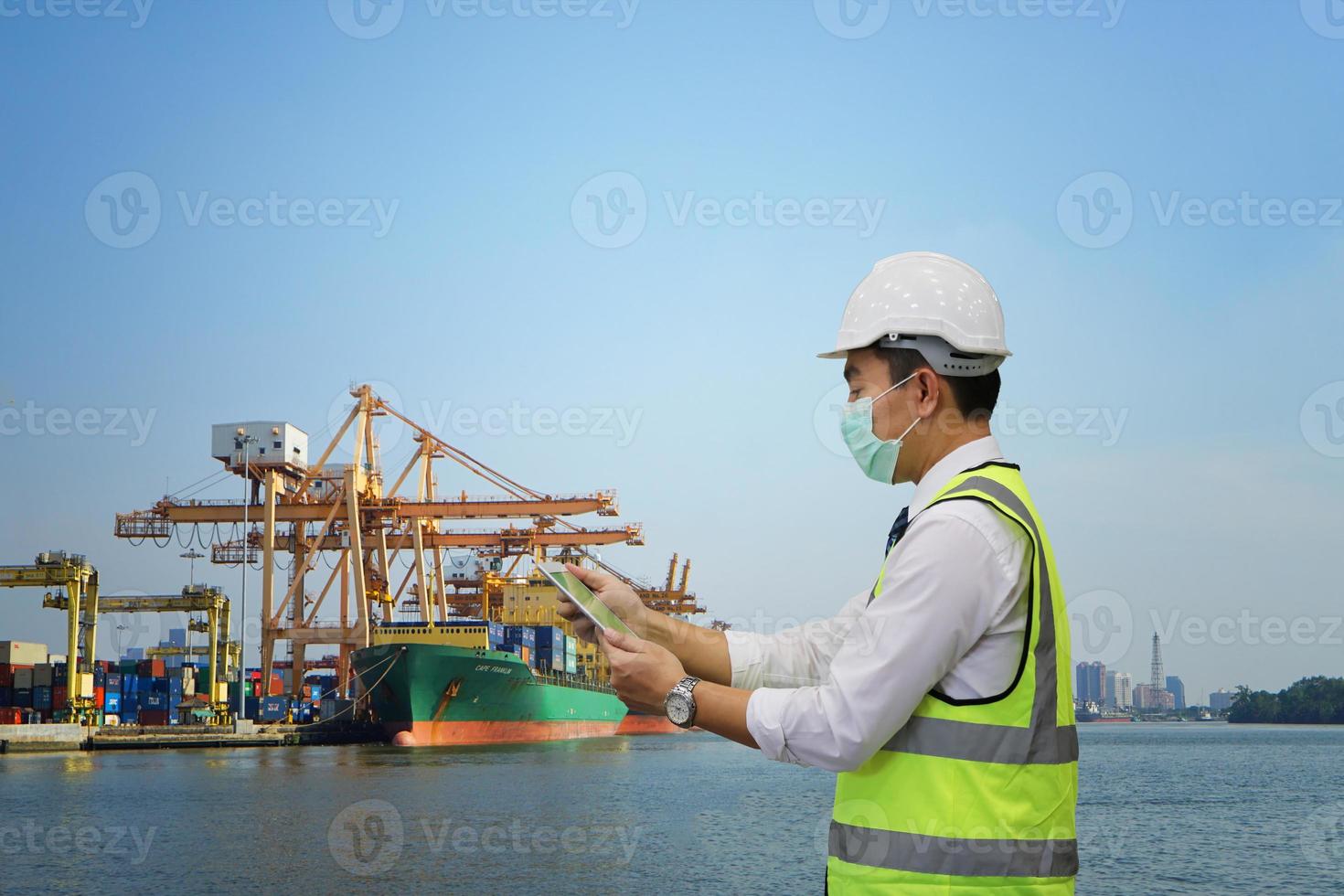 Foreman control loading Containers box from Cargo freight ship for import export. photo
