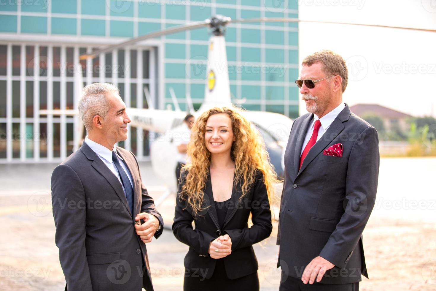 Successful business people standing together widen out showing strong relationship of worker community. A team of businessman and businesswoman expressing a strong group teamwork at the modern office. photo