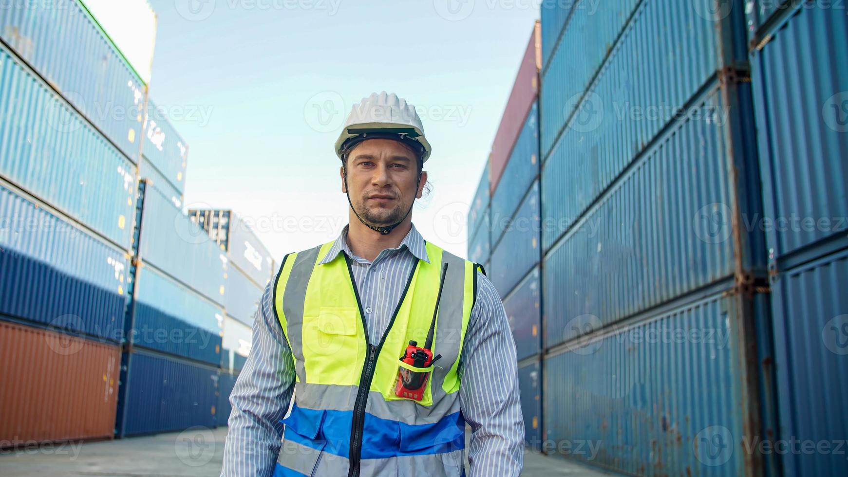 Foreman control loading Containers box from Cargo freight ship for import export. photo