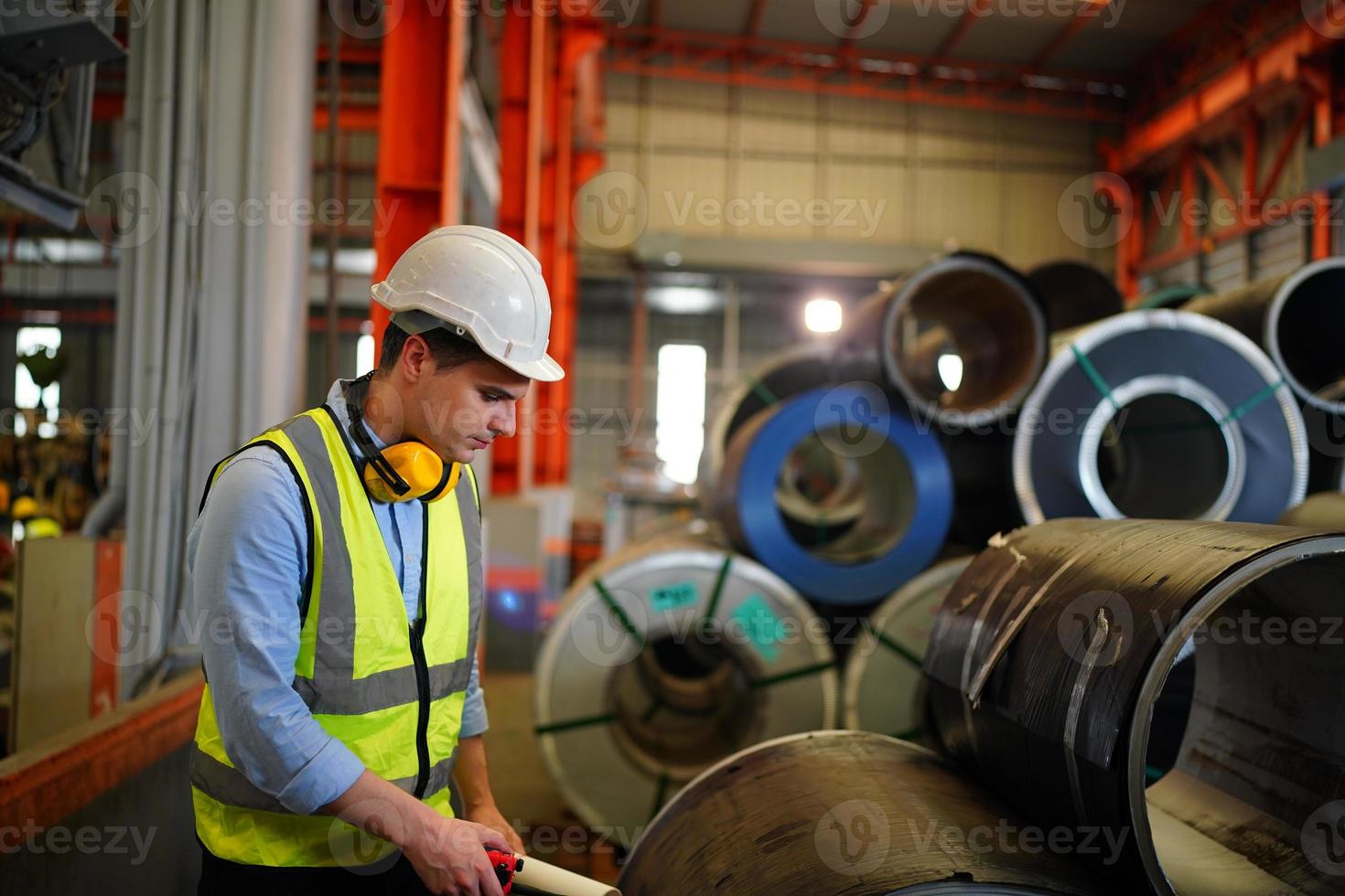 Industry worker Foreman or worker work at factory site check up machine or products in site. Engineer or Technician checking Material or Machine on Plant. Industrial and Factory. photo