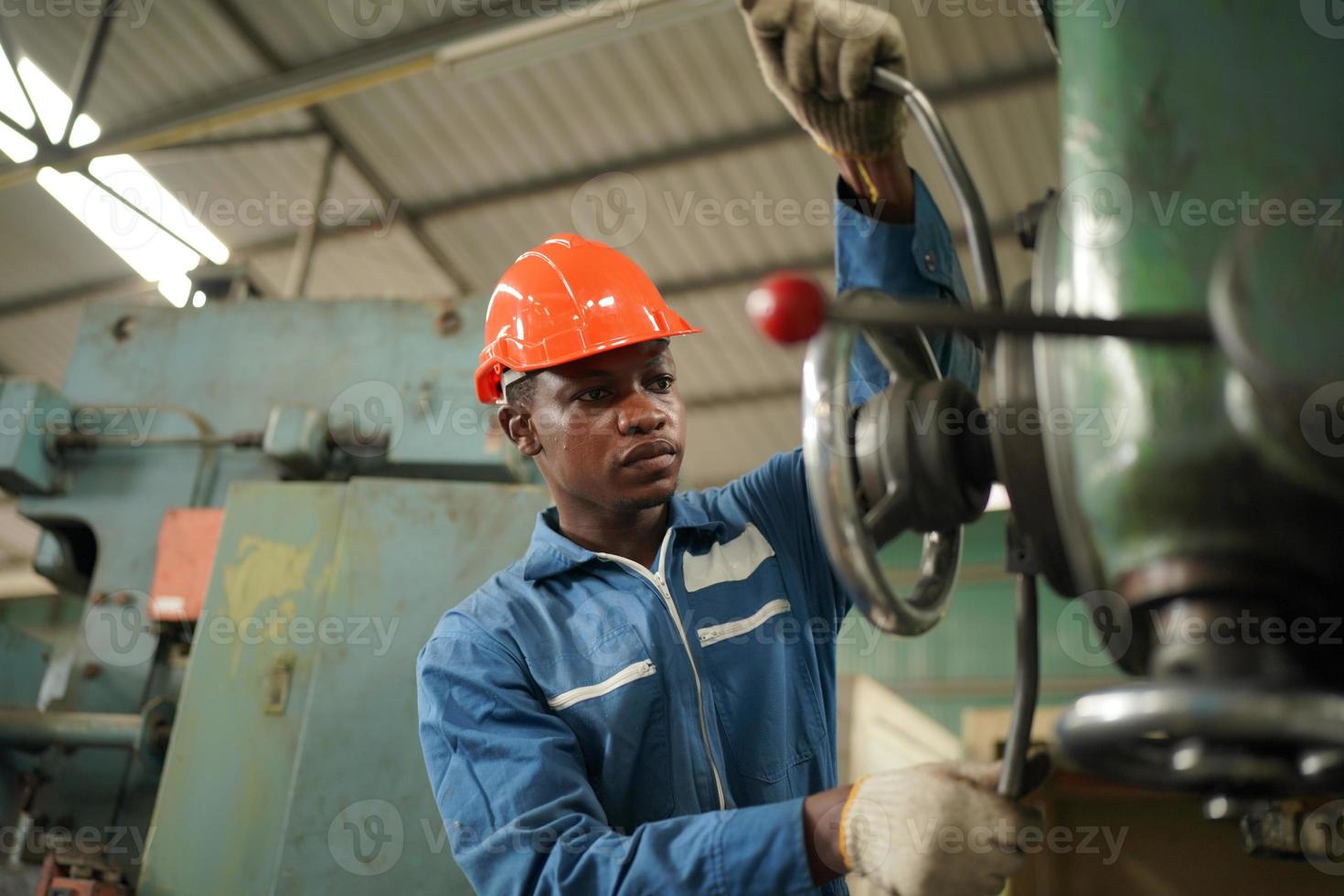 Maintenance Engineers is working in front of the automated CNC machinery repair on a maintenance checklist at the production line. photo