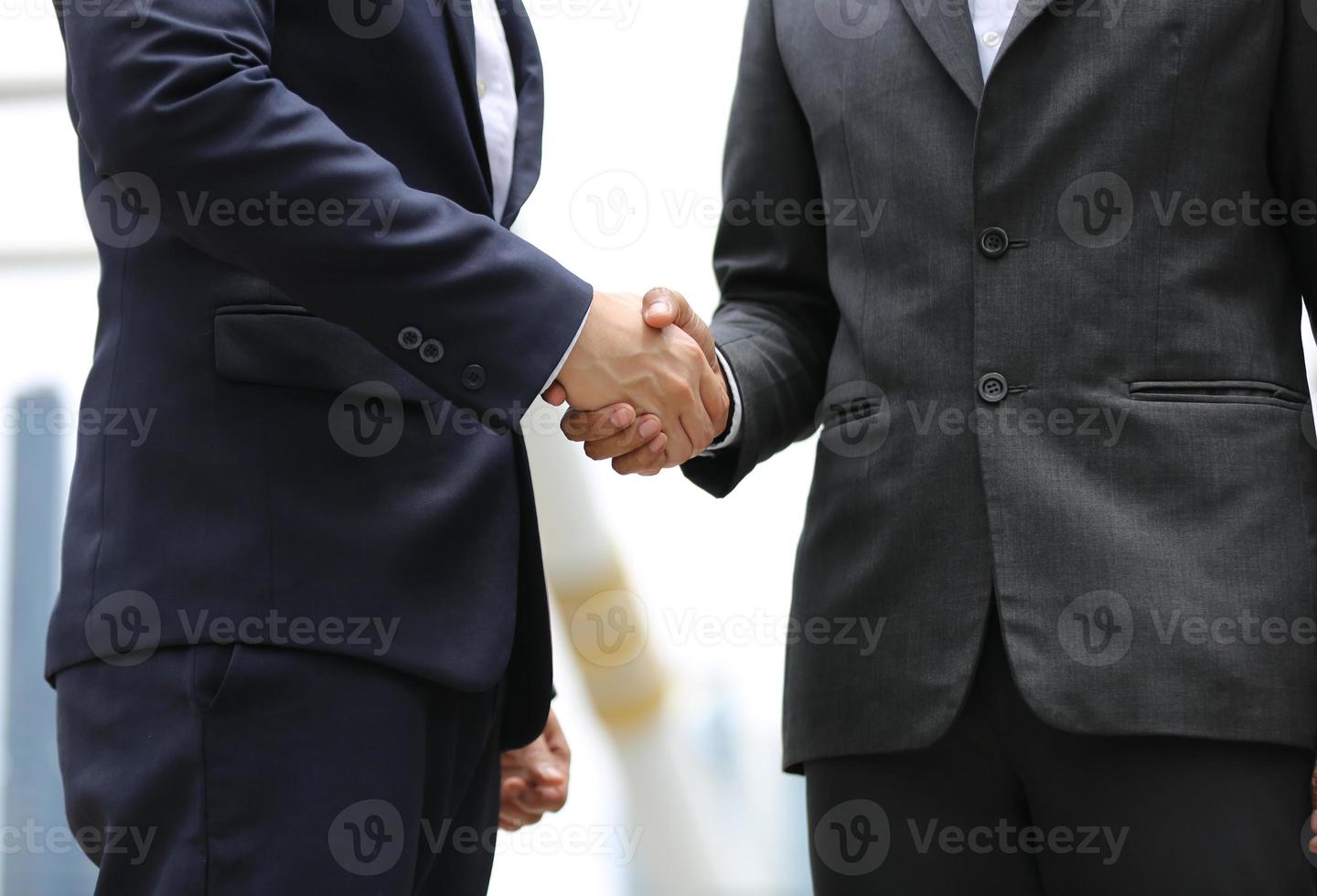 Business people shaking hands after successful negotiations photo