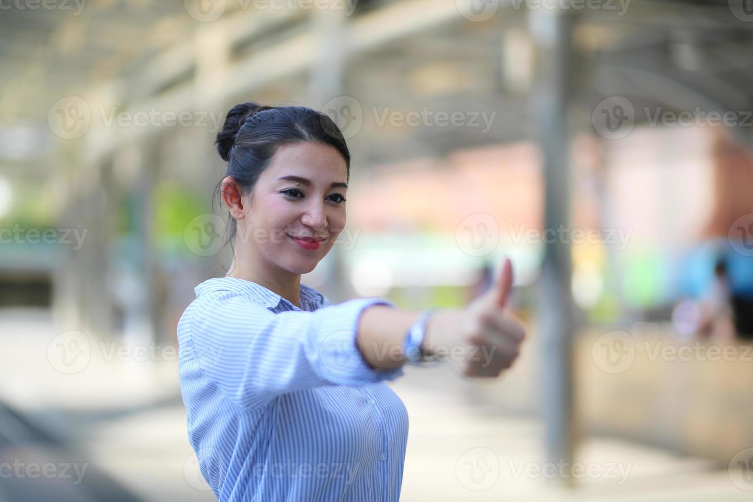 Portrait of young beautiful business woman at outside. Crossed arms photo