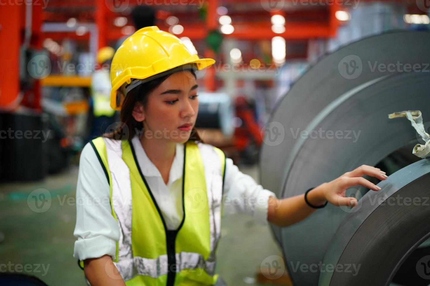 Female worker Foreman or worker work at factory site check up machine or products in site. Engineer or Technician checking Material or Machine on Plant. Industrial and Factory. photo