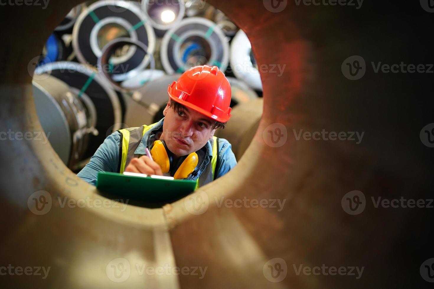 Industry worker Foreman or worker work at factory site check up machine or products in site. Engineer or Technician checking Material or Machine on Plant. Industrial and Factory. photo