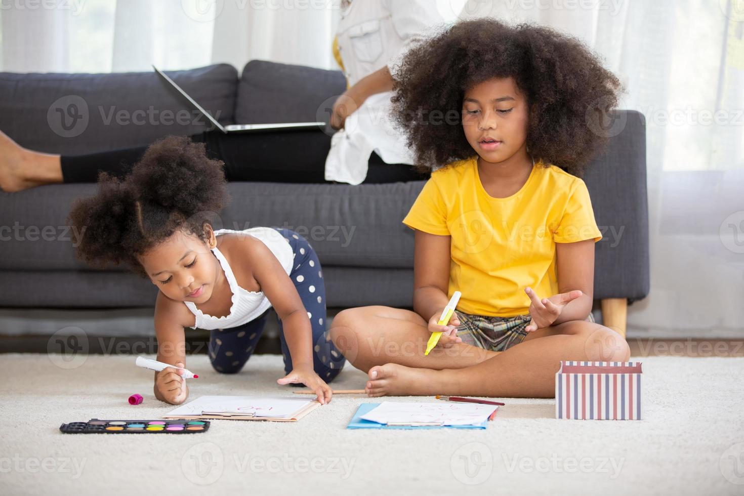 Portrait of happy young african American family with little kids sit relax on couch cuddling, smiling black parents rest on sofa hug preschooler children posing for picture at home together photo