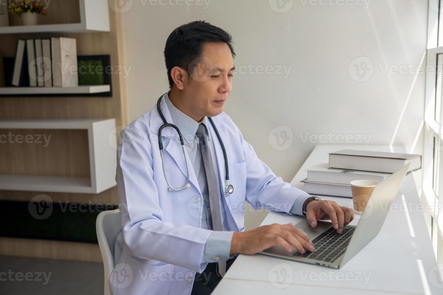 Doctor using laptop in hospital photo