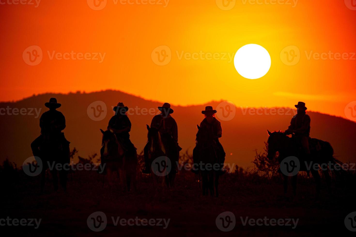 vaquero de silueta a caballo contra una hermosa puesta de sol, vaquero y caballo a primera luz, montaña, río y estilo de vida con fondo de luz natural foto