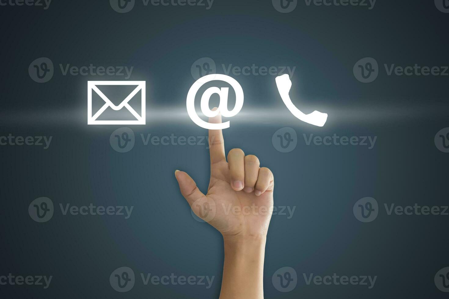 Hand pressing telephone, email button icon over blue background. Customer support concept photo