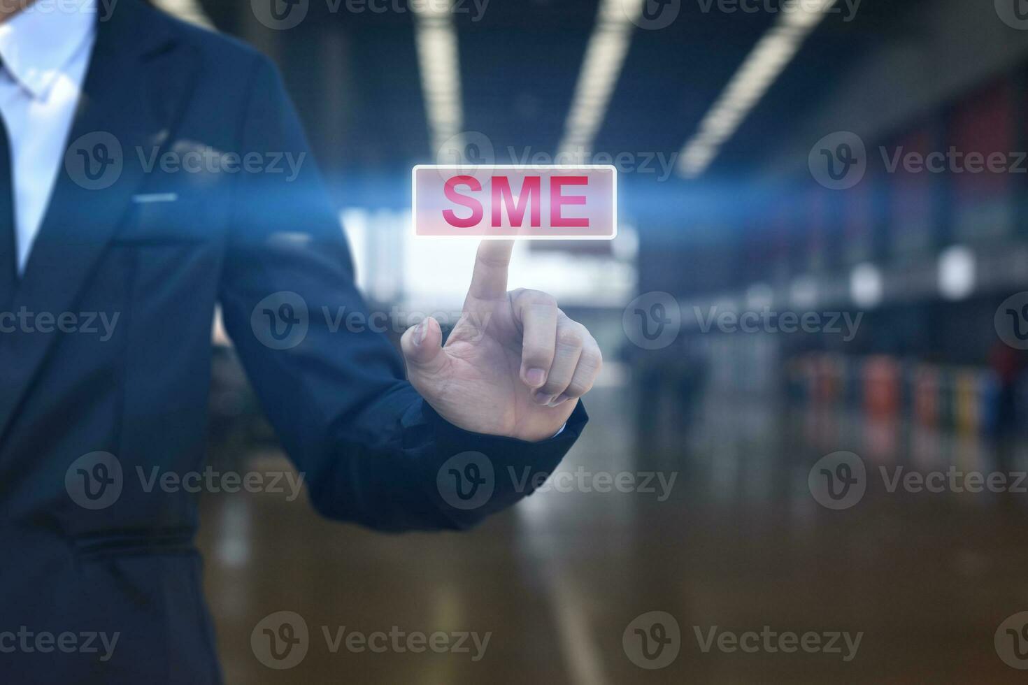 Businessman hand pressing button SME icon. Concept of small and medium-sized enterprises business. photo