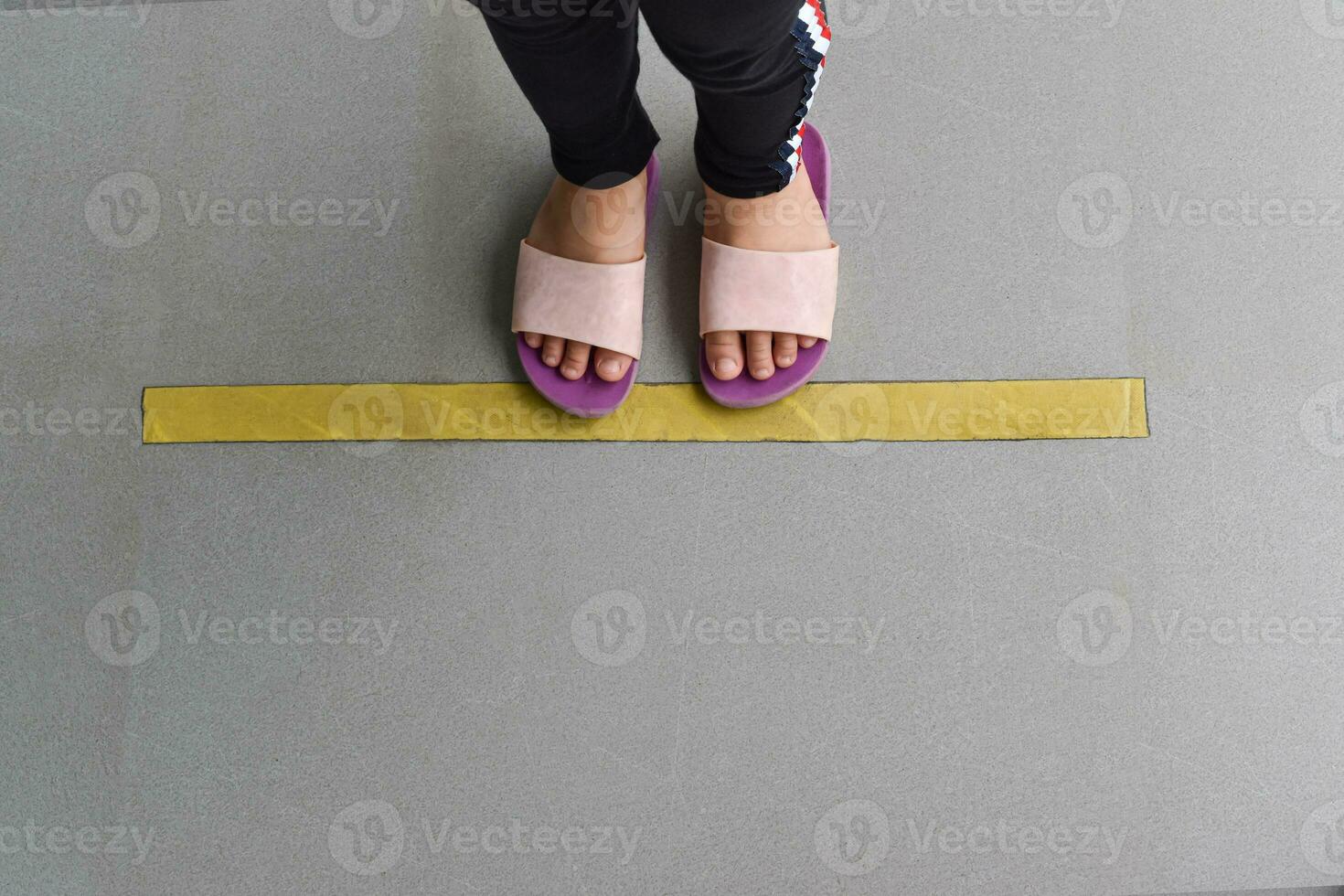 Top down of feet stand in line on flooring. Concept of public space practicing Social distancing. photo