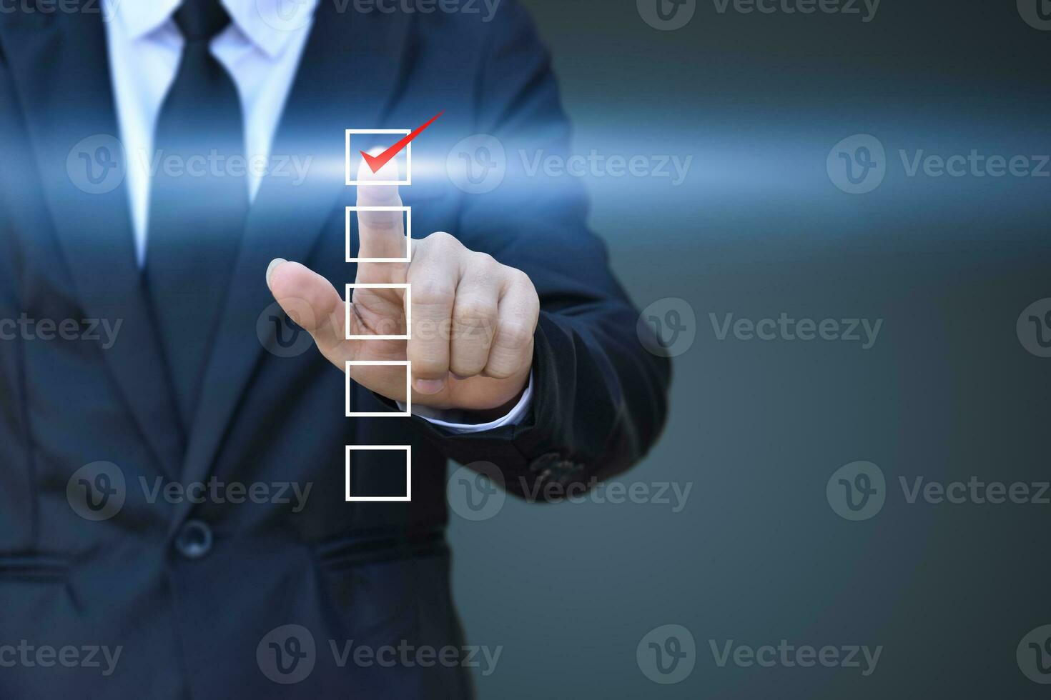 Businessman touch checking mark in a checkbox on blue background. copy space photo