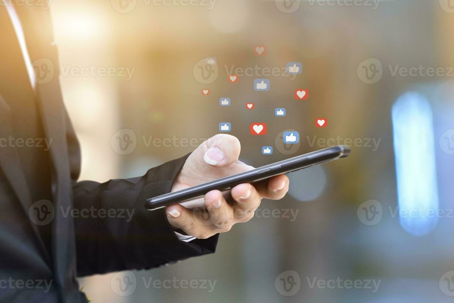 Close-up of businessman hands using mobile smartphone with social media icon. Idea for business, online marketing and technology. photo