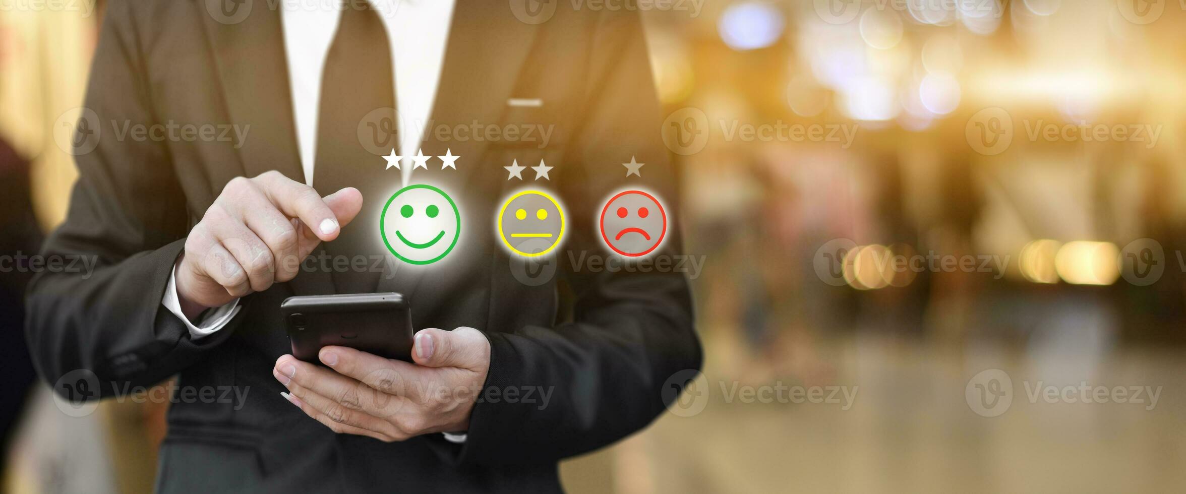 Businessman pressing face emoticon in smartphone at display on virtual screen. Concept of customer service satisfaction evaluation and feedback. photo